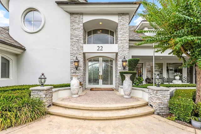 a front view of a house with a fountain