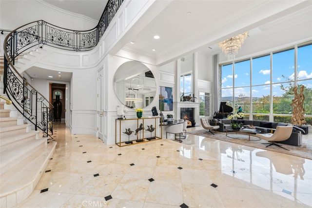 a view of a hallway with dining area and chandelier