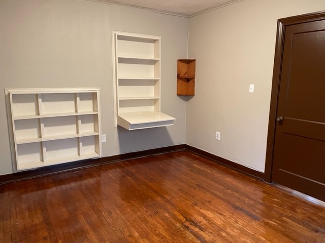 7145 Moline Street, Unit B Houston, TX 77087 - Photo 2 of 8 a view of an empty room with a window and wooden floor