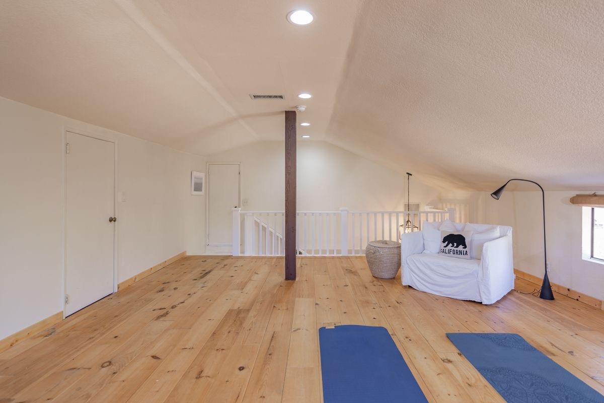 930 Fairview Road Ojai, CA 93023 - Photo 24 of 30 a bedroom with a bed and wooden floor