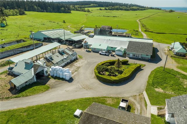 an aerial view of a house with garden space and ocean view