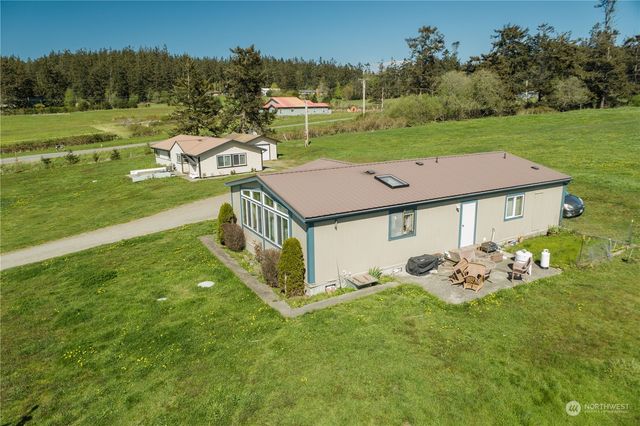 a front view of a house with yard and green space