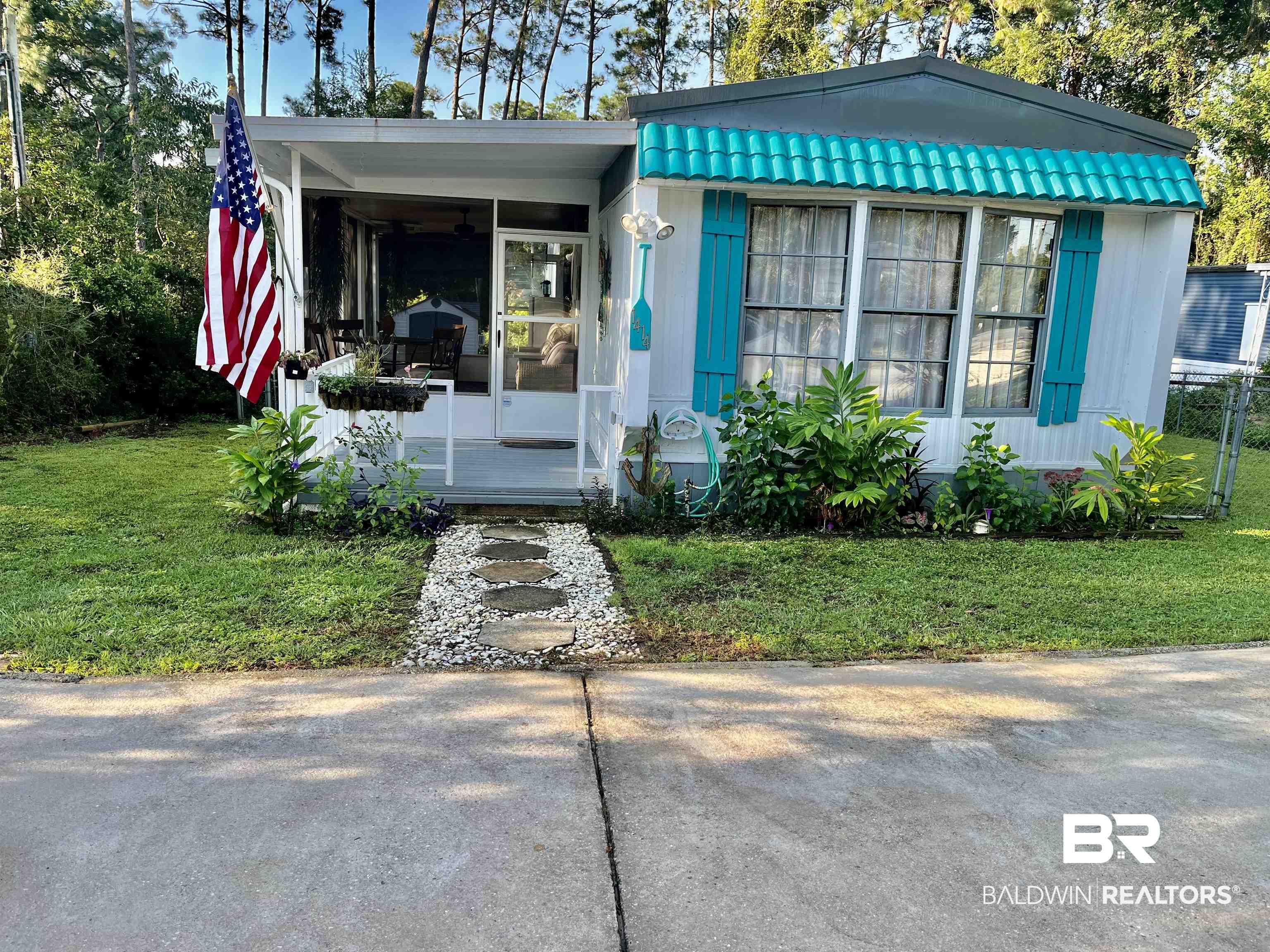 1414 Ridgewood Drive Lillian, AL 36549 - Photo 1 of 26 View of front of home featuring a carport and a front lawn