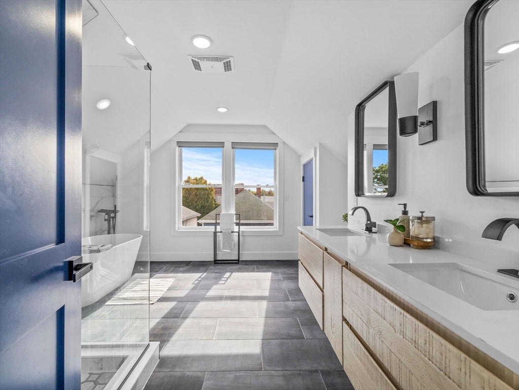 62 Governor Winthrop Road, Unit 2 Somerville, MA 02145 - Photo 14 of 32 a bathroom with a double vanity sink and a large mirror