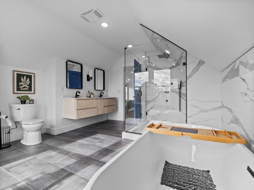 62 Governor Winthrop Road, Unit 2 Somerville, MA 02145 - Photo 15 of 32 a bathroom with a sink a toilet and a bathtub