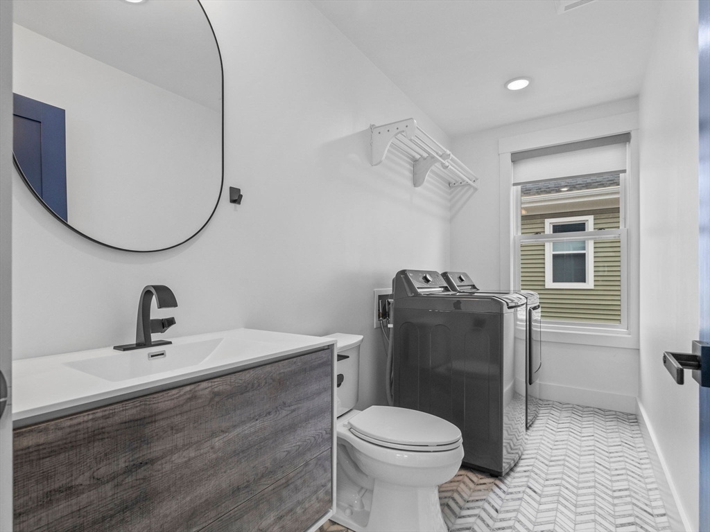 62 Governor Winthrop Road, Unit 2 Somerville, MA 02145 - Photo 16 of 32 a bathroom with a sink toilet and a mirror