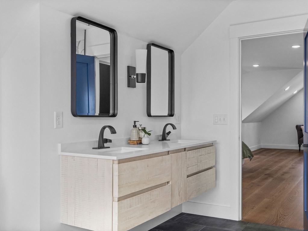 62 Governor Winthrop Road, Unit 2 Somerville, MA 02145 - Photo 17 of 32 a bathroom with a double vanity sink and mirror
