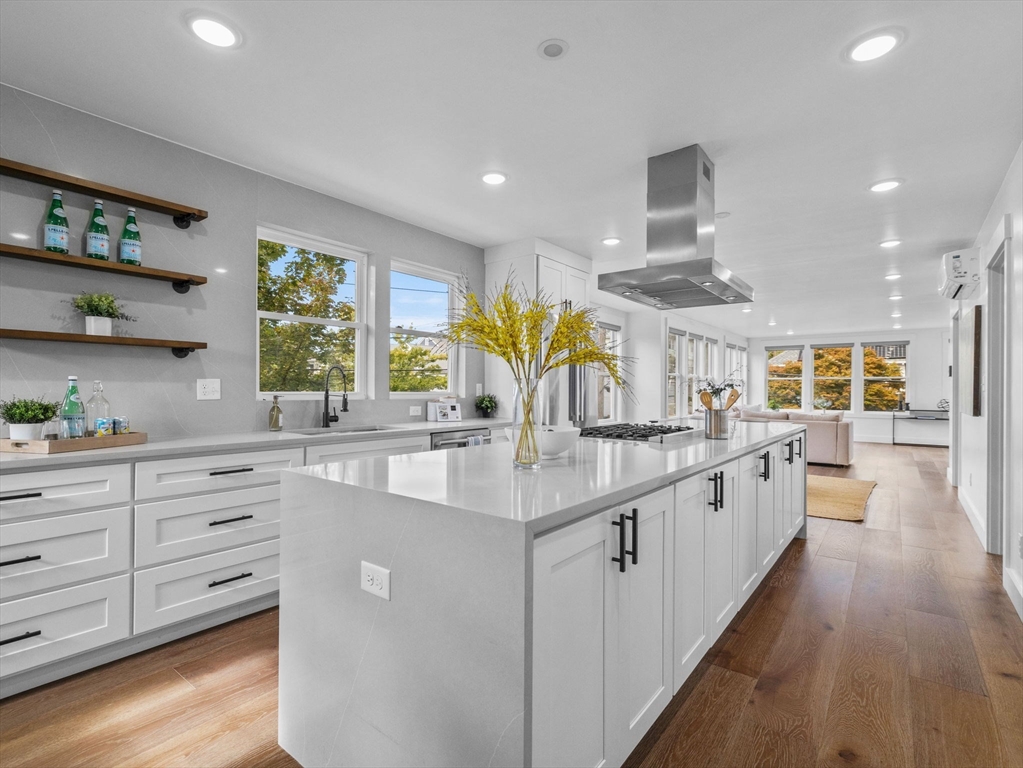 62 Governor Winthrop Road, Unit 2 Somerville, MA 02145 - Photo 2 of 32 a large kitchen with kitchen island a large counter space a sink a window and stainless steel appliances