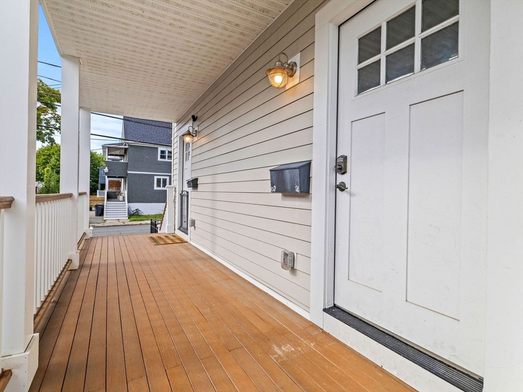 62 Governor Winthrop Road, Unit 2 Somerville, MA 02145 - Photo 25 of 32 a view of a patio with wooden floor and fence