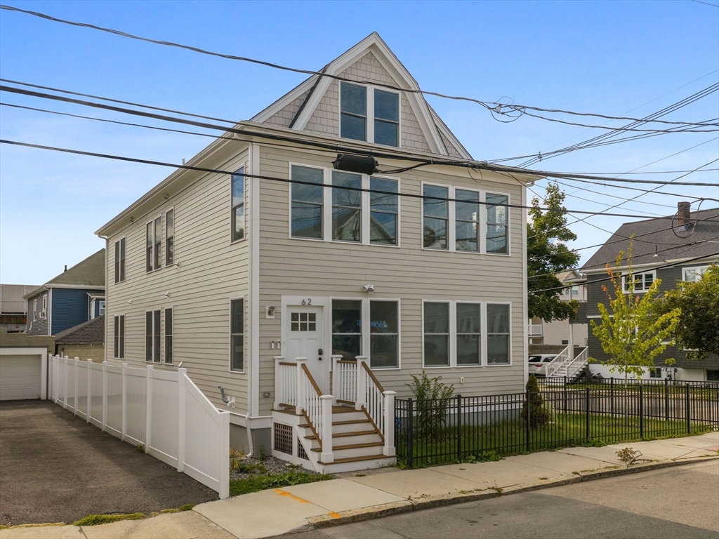 62 Governor Winthrop Road, Unit 2 Somerville, MA 02145 - Photo 28 of 32 a front view of a house with a garage