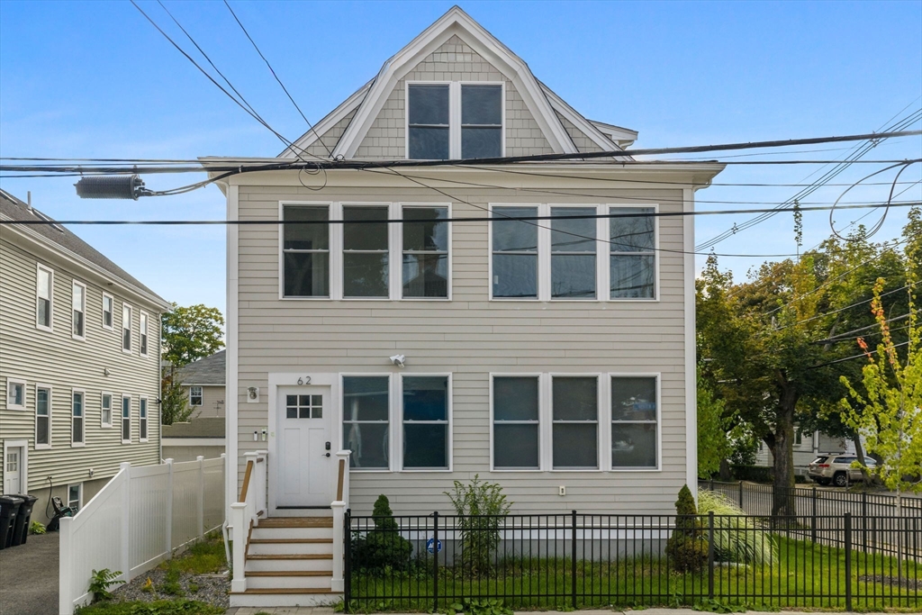 62 Governor Winthrop Road, Unit 2 Somerville, MA 02145 - Photo 29 of 32 a front view of a house with a yard