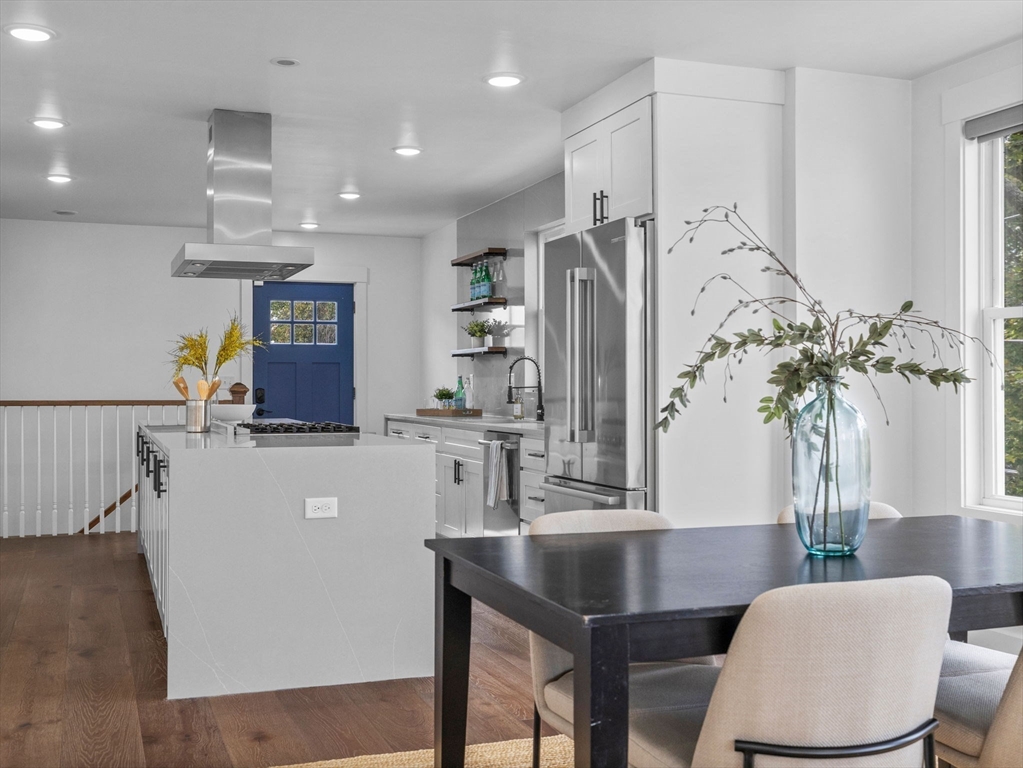 62 Governor Winthrop Road, Unit 2 Somerville, MA 02145 - Photo 6 of 32 a living room with furniture a potted plant and a chandelier