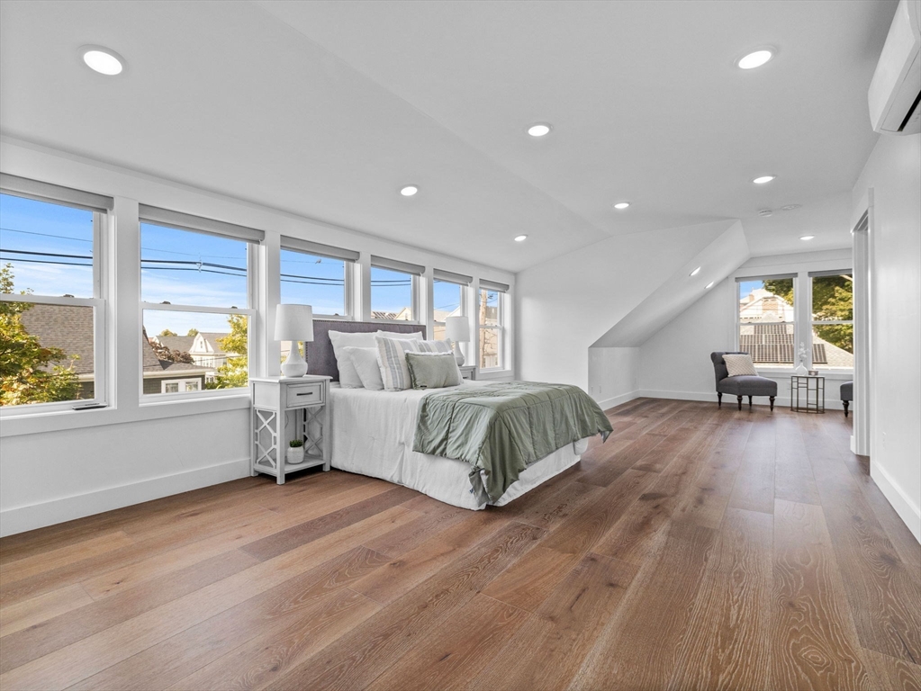 62 Governor Winthrop Road, Unit 2 Somerville, MA 02145 - Photo 8 of 32 a spacious bedroom with a large bed and a large window