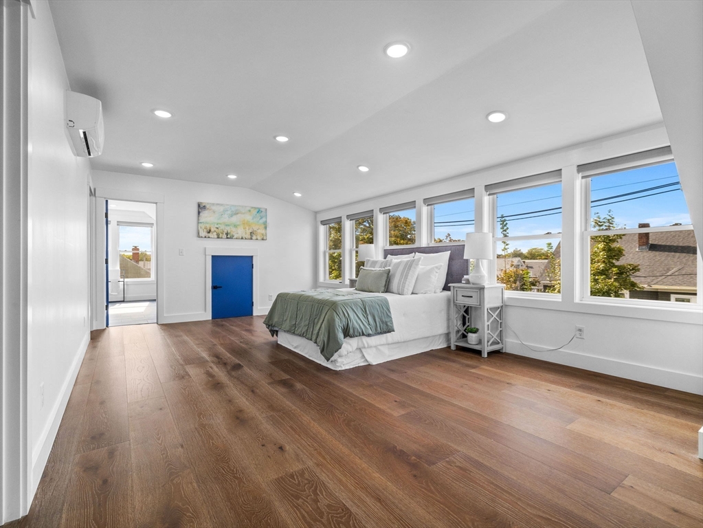 62 Governor Winthrop Road, Unit 2 Somerville, MA 02145 - Photo 10 of 32 a spacious bedroom with a large bed and a large window