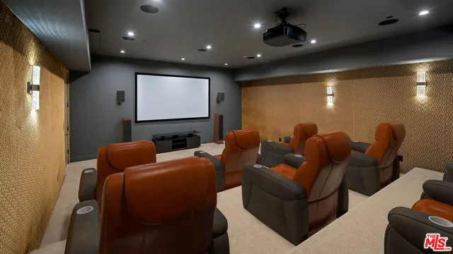 a media room with lots of chairs and a projector screen