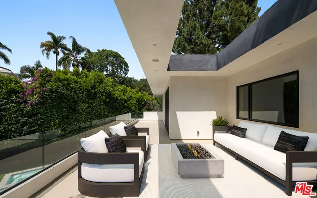 a terrace with outdoor seating and trees