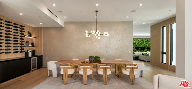 a dining room with furniture a chandelier and window