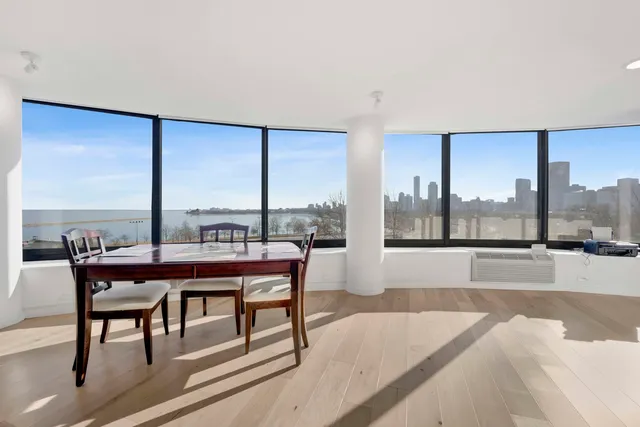 a living room with a large window and a table