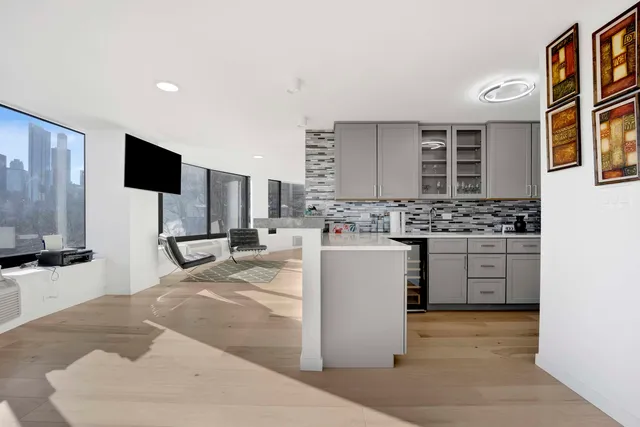 a kitchen with stainless steel appliances kitchen island granite countertop a stove a sink and a microwave