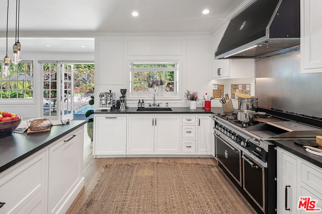 3228 Berry Drive Studio City, CA 91604 - Photo 13 of 40 a kitchen with a sink stove top oven and cabinets