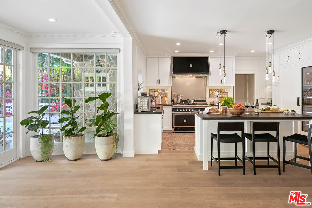 3228 Berry Drive Studio City, CA 91604 - Photo 15 of 40 a kitchen with a potted plant and a living area