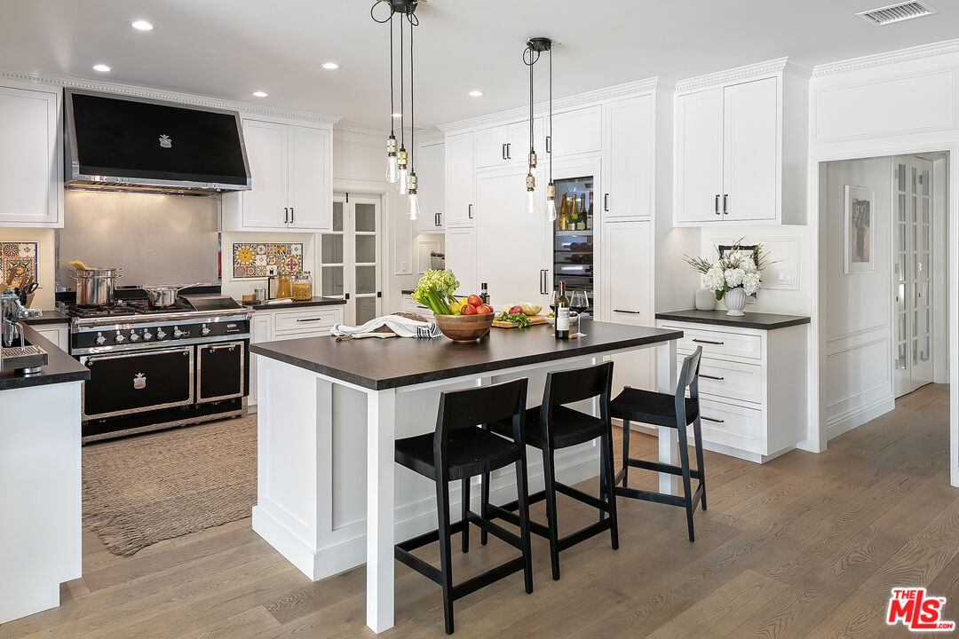3228 Berry Drive Studio City, CA 91604 - Photo 10 of 40 a kitchen with stainless steel appliances kitchen island granite countertop a stove a sink and a refrigerator