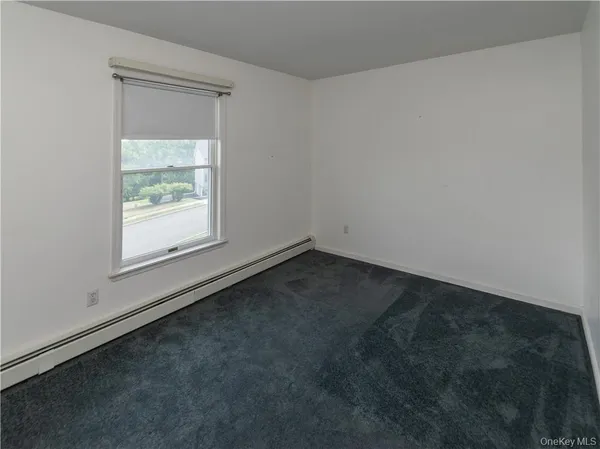 a bathroom with a granite countertop sink mirror and toilet
