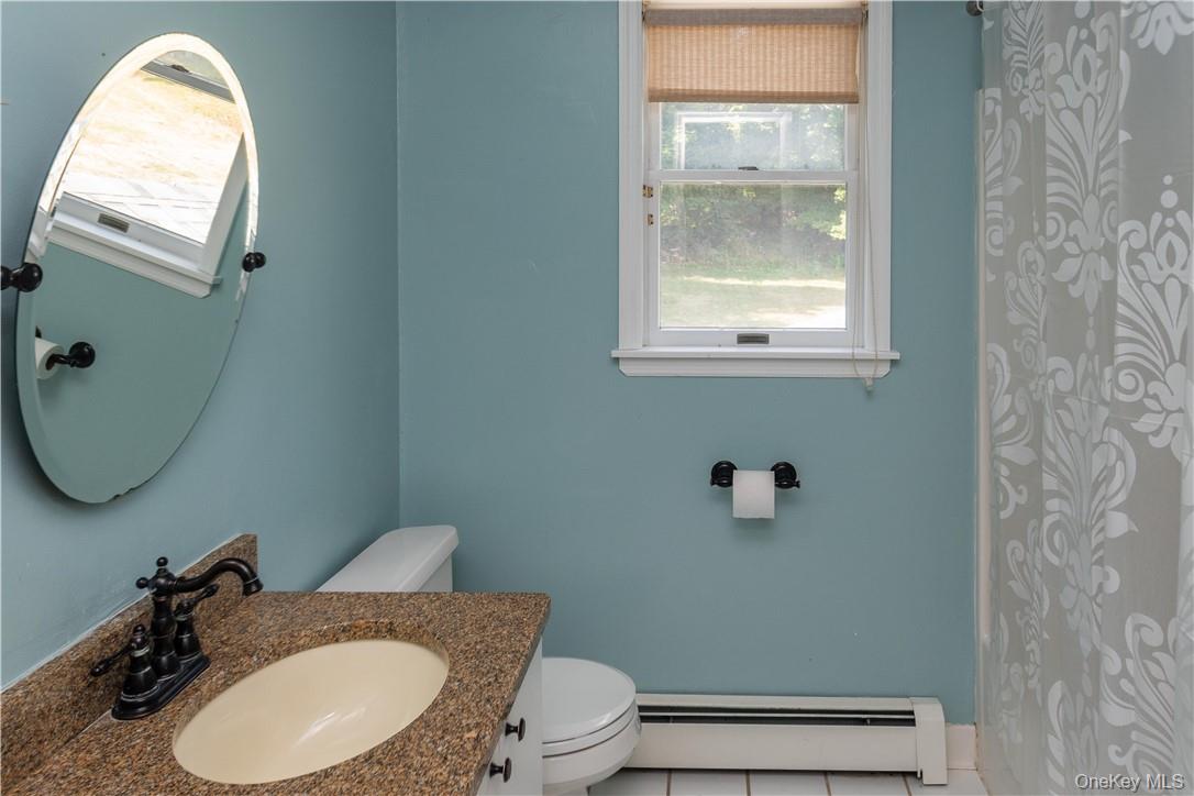 11 Peterson Road Monroe, NY 10950 - Photo 18 of 28 a bathroom with a granite countertop toilet and a sink