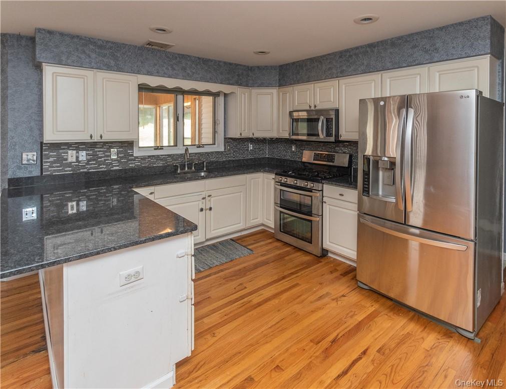 11 Peterson Road Monroe, NY 10950 - Photo 4 of 28 a kitchen with granite countertop stainless steel appliances a sink a refrigerator a window and cabinets