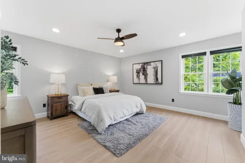 a spacious bedroom with a large bed and a window