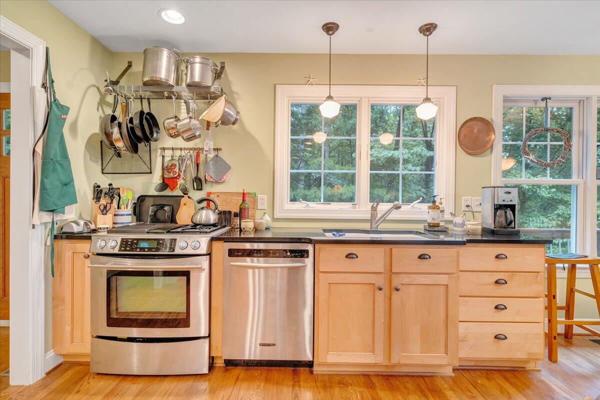 932 Clear Pointe Run Lynch Station, VA 24571 - Photo 27 of 154 a kitchen with granite countertop a stove a sink and a chandelier