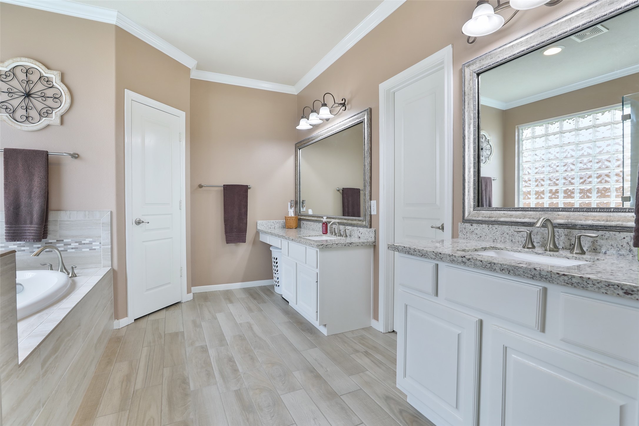 20519 Windrose Bend Drive Spring, TX 77379 - Photo 22 of 37 Luxurious ensuite featuring a modern dual-sink vanities, makeup area, spacious glass-enclosed shower, soaking tub, and walk-in closet.