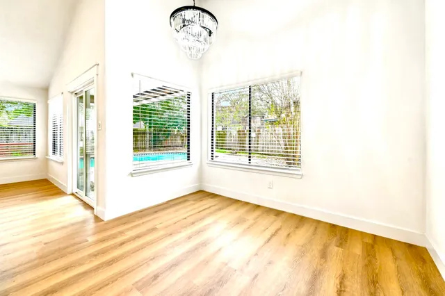 a view of a bedroom with a bed and a window