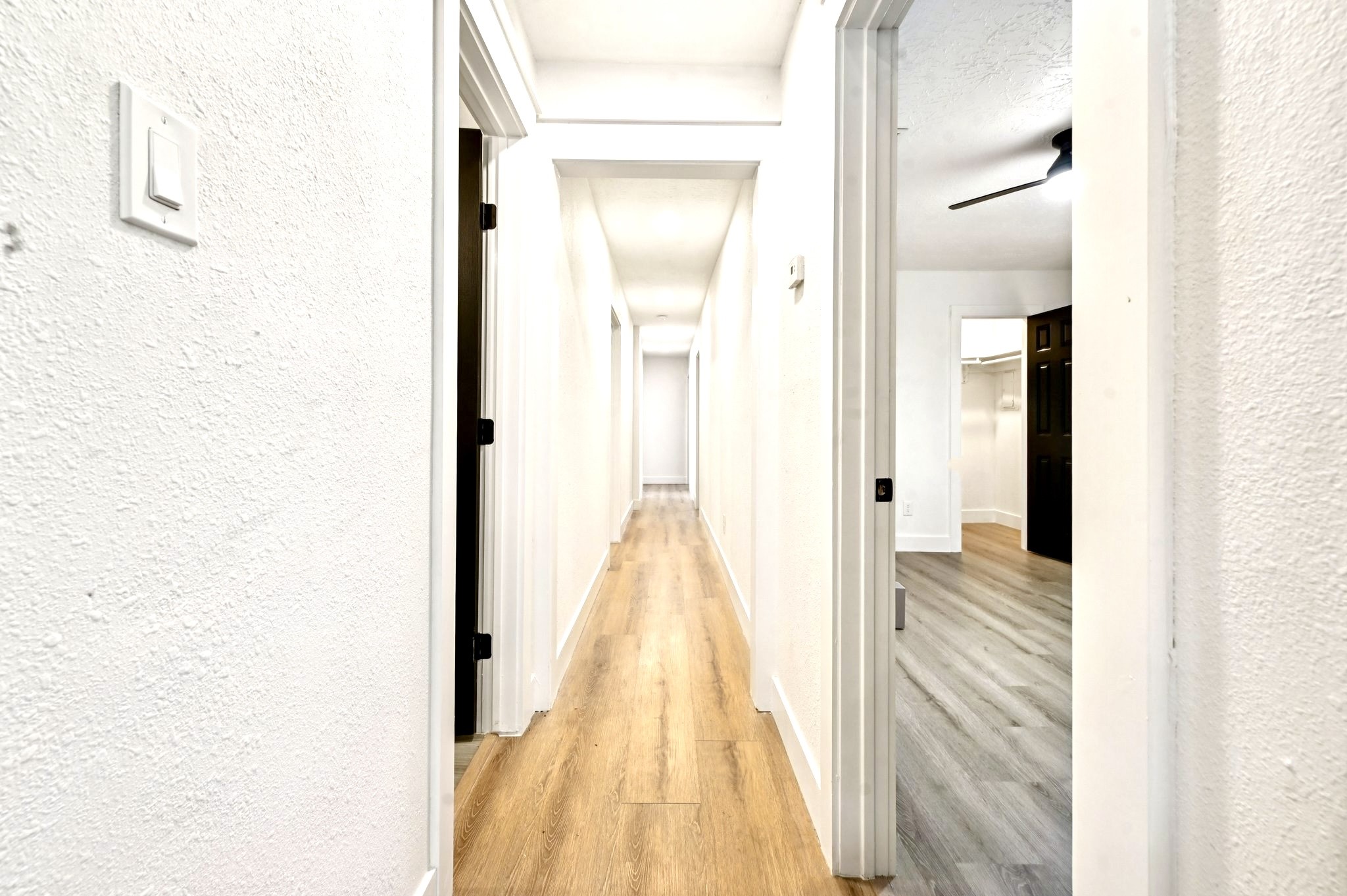 17307 Eden Court Spring, TX 77379 - Photo 28 of 43 a view of a hallway with wooden floor and a bathroom