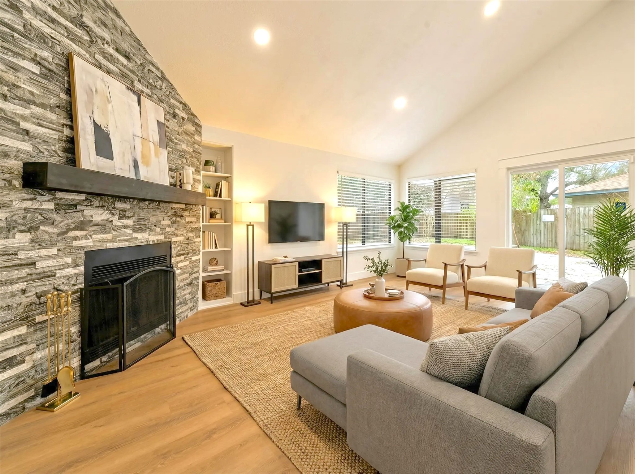 17307 Eden Court Spring, TX 77379 - Photo 10 of 43 a living room with furniture a fireplace and a flat screen tv