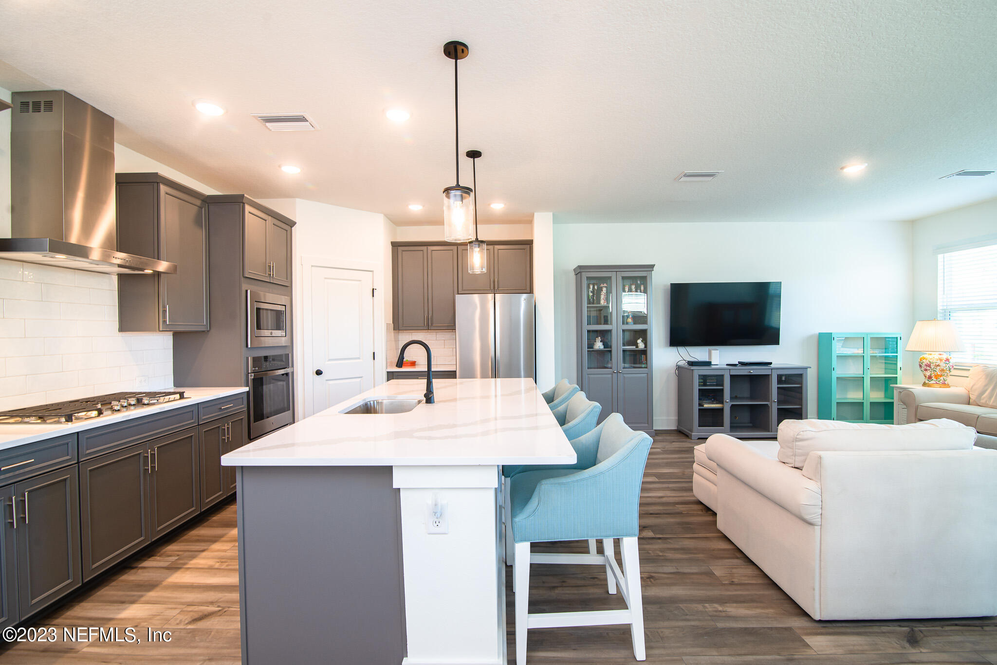 9868 Element Road Jacksonville, FL 32256 - Photo 12 of 36 a large kitchen with kitchen island a sink table and chairs