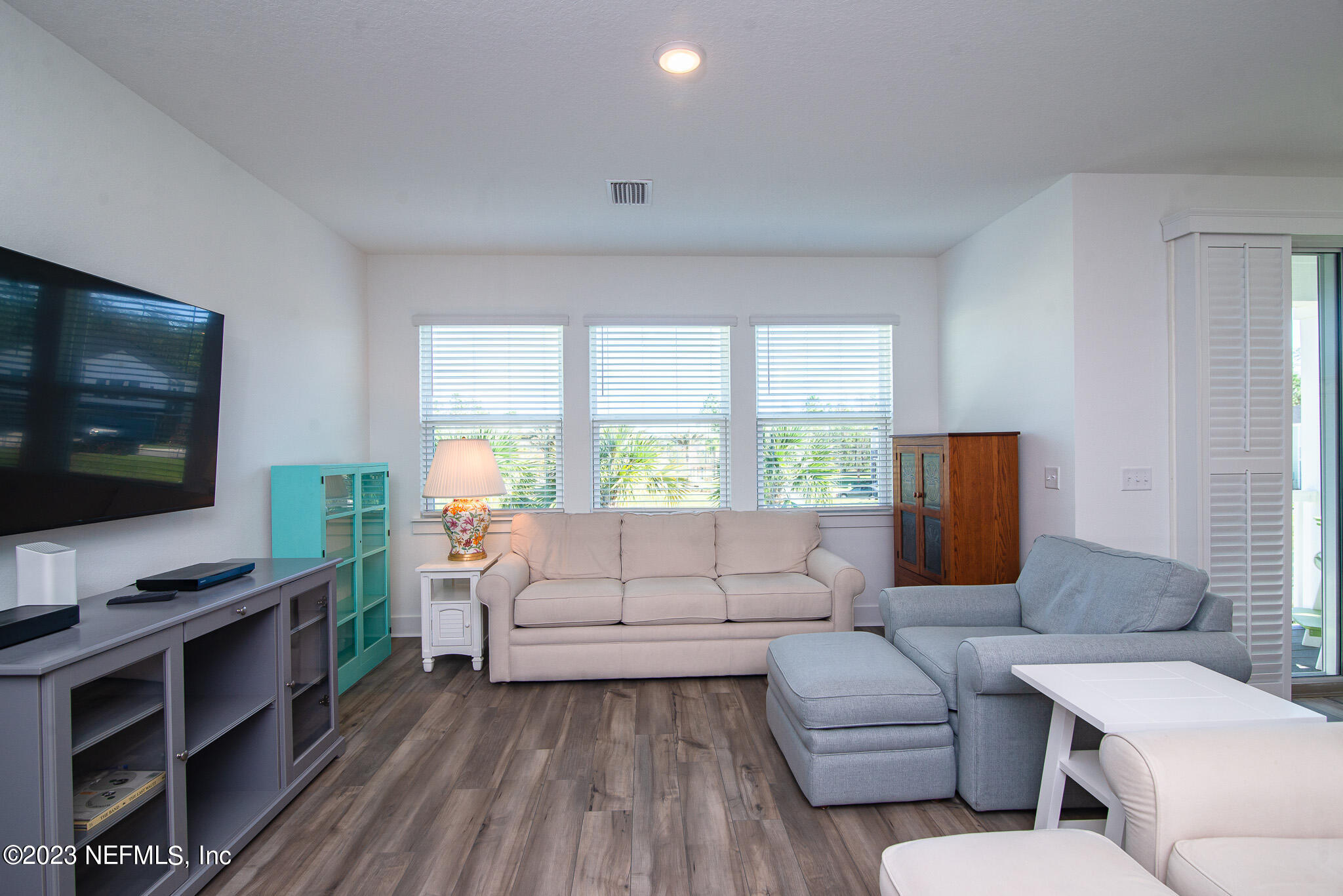 9868 Element Road Jacksonville, FL 32256 - Photo 15 of 36 a living room with furniture and a flat screen tv