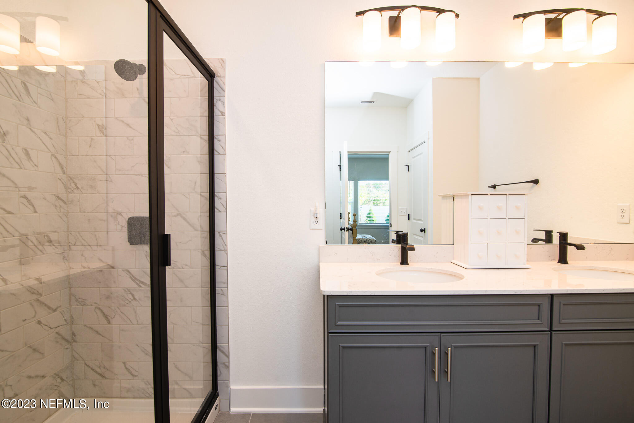 9868 Element Road Jacksonville, FL 32256 - Photo 18 of 36 a bathroom with a sink and a mirror
