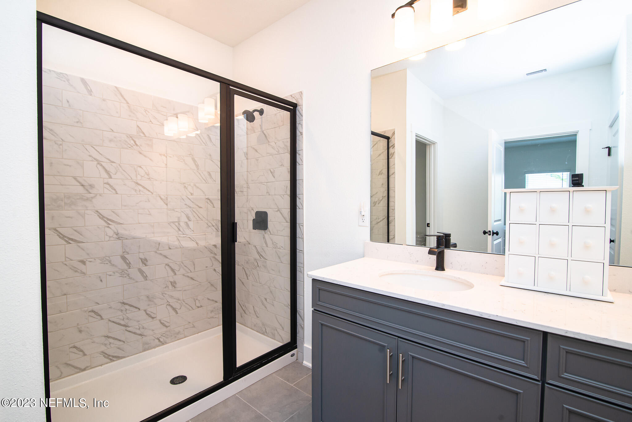 9868 Element Road Jacksonville, FL 32256 - Photo 19 of 36 a bathroom with a sink and a mirror