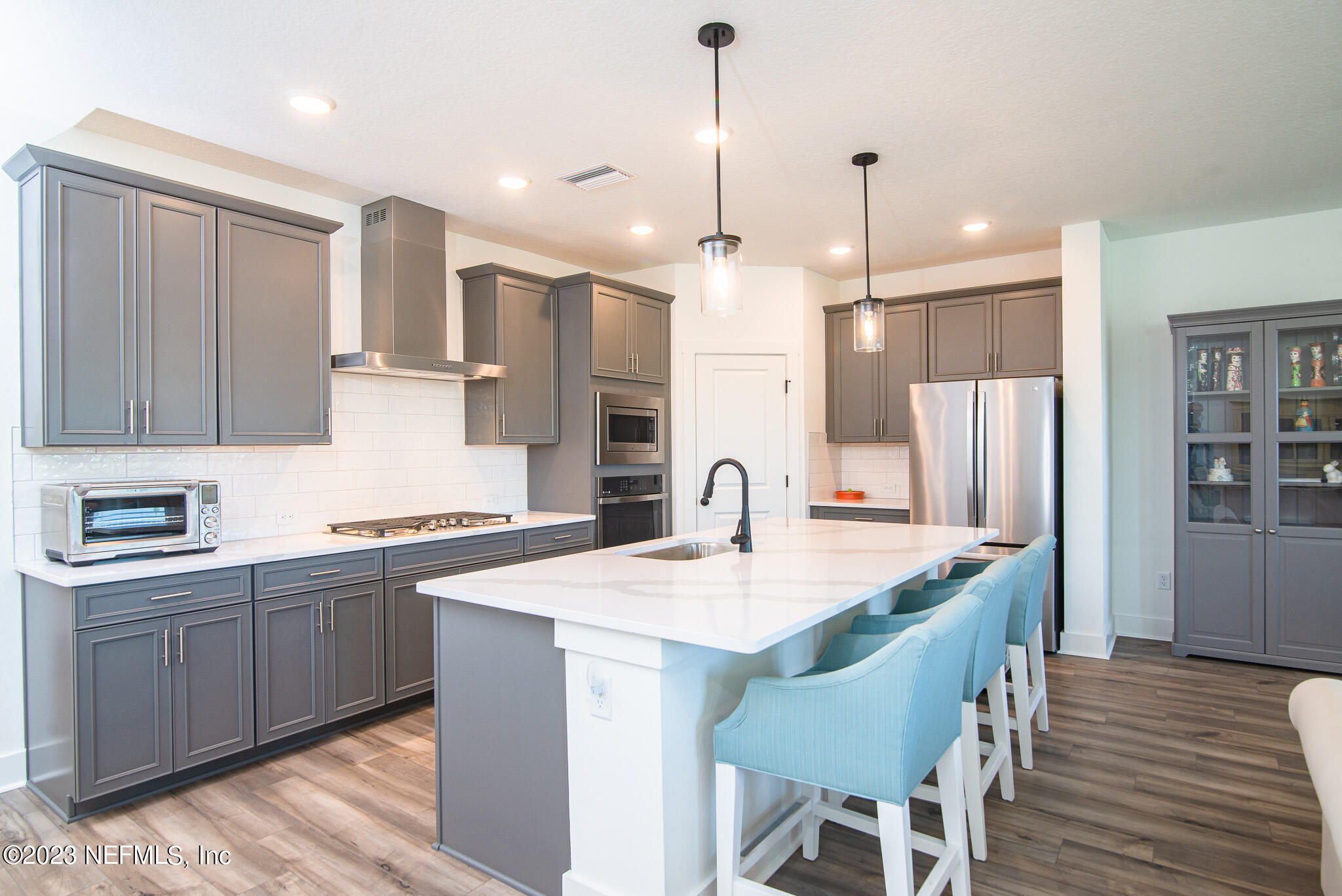 9868 Element Road Jacksonville, FL 32256 - Photo 4 of 36 a kitchen with granite countertop a sink a center island stainless steel appliances and cabinets