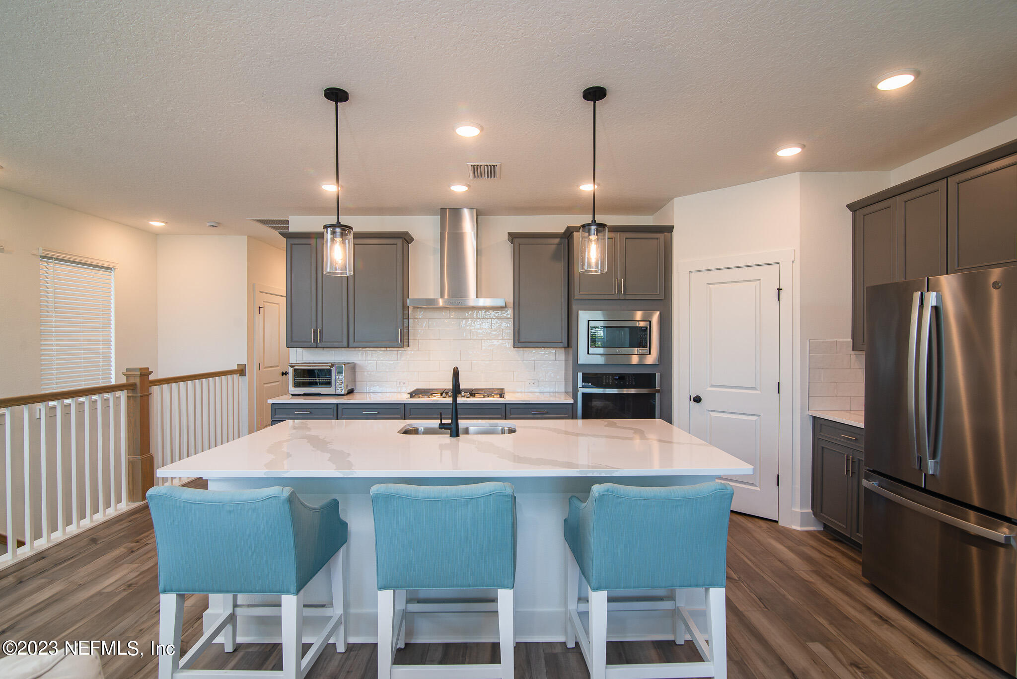 9868 Element Road Jacksonville, FL 32256 - Photo 9 of 36 a kitchen with stainless steel appliances a dining table chairs sink and microwave