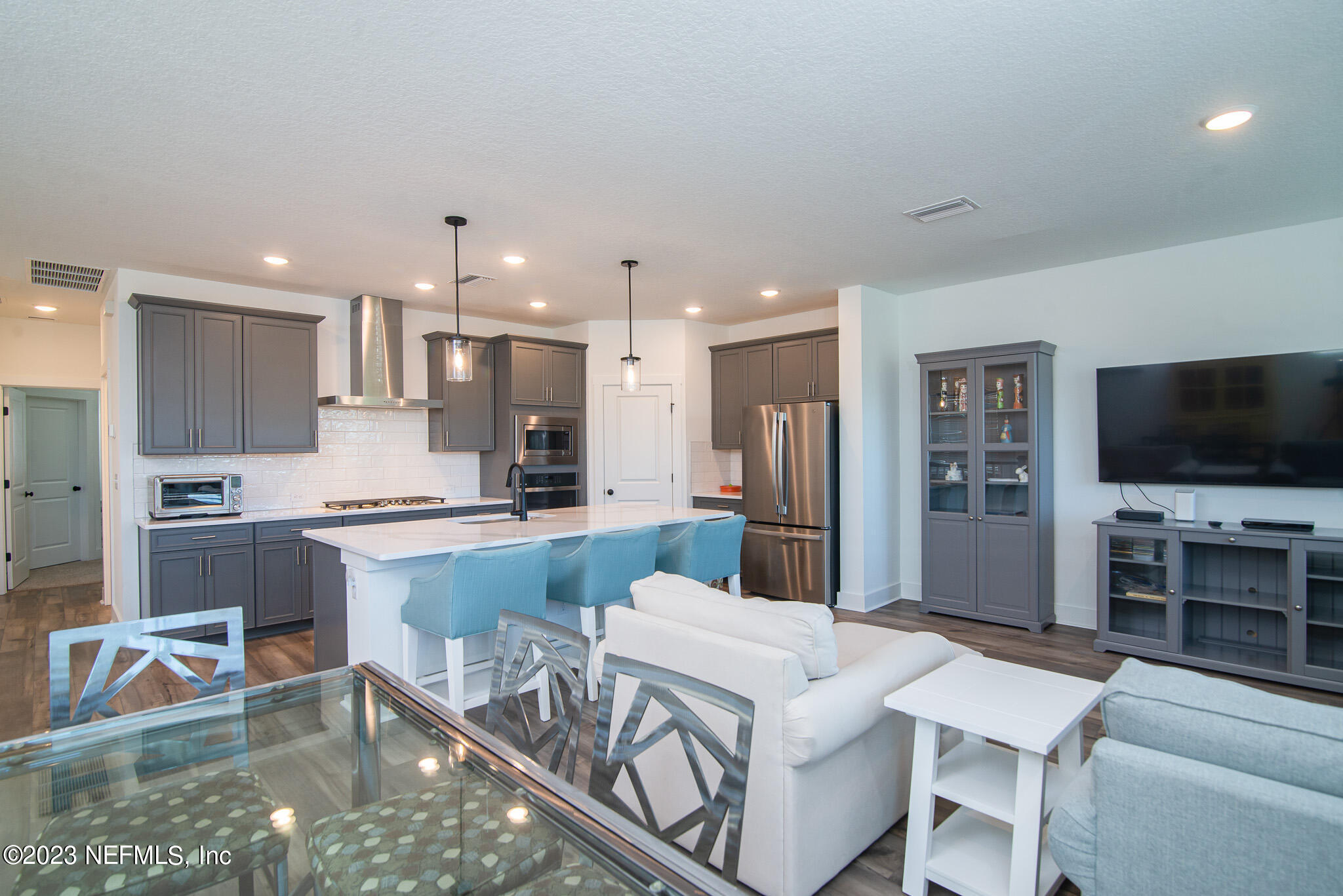 9868 Element Road Jacksonville, FL 32256 - Photo 10 of 36 a large white kitchen with a table and chairs in it