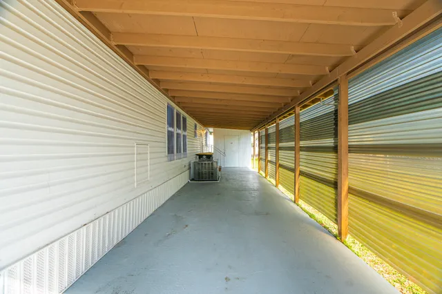 a view of a house with backyard and a tree