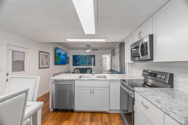 a kitchen that has a sink and a stove in it
