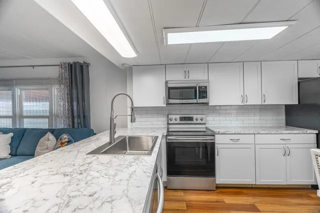 a kitchen with a sink stove and cabinets