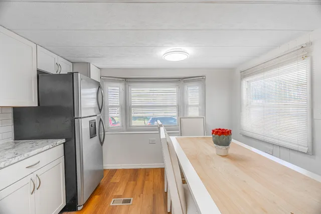 a kitchen with stainless steel appliances a refrigerator and window
