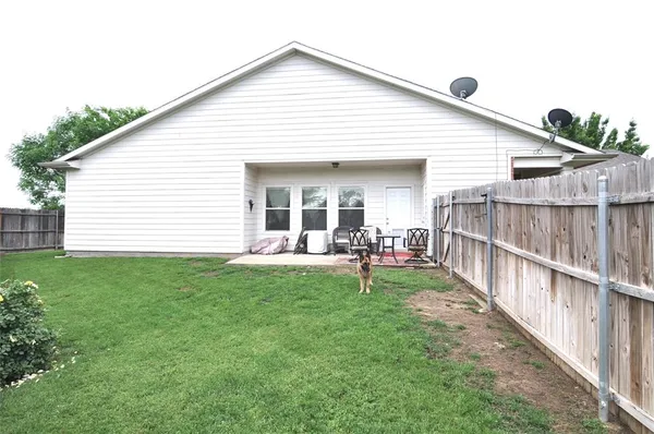 a view of a backyard with table and chairs