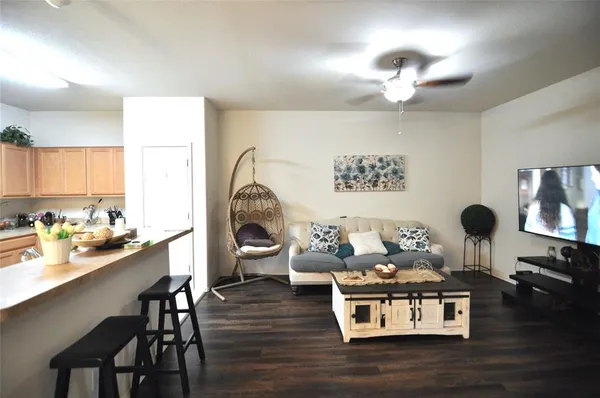 a living room with furniture and wooden floor