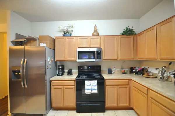 a kitchen with a refrigerator and cabinets
