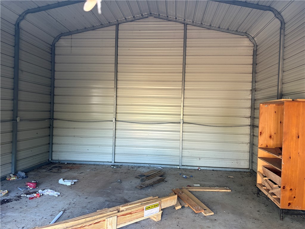 1108 Trotter Road Anderson, SC 29626 - Photo 21 of 27 A spacious metal outbuilding features high vaulted ceilings and a durable concrete floor.